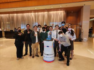Group Photo with Hotel Robot