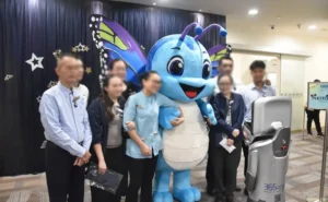 The robot serves as a photographer, capturing photos of the healthcare staff and mascot at the photobooth.
